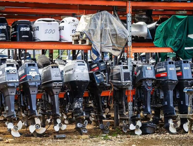A row of high-quality used outboard motors from major brands on display stands